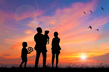 family against sunset backdrop