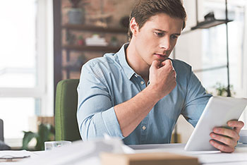 concerned man on tablet