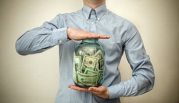 man holding money jar